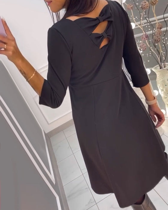 Solid color dress with bow at back