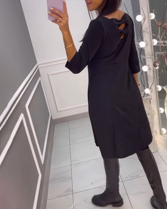Solid color dress with bow at back